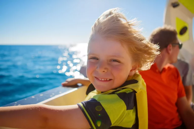 little kid boy enjoying sailing boat trip